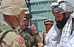 Major Michael O'Neal with 486th Civil Affair Brigade shakes hand with one of the teachers of the Dani Ghuch school.