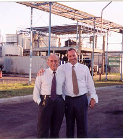 Picture of two men standing in an industrial area.