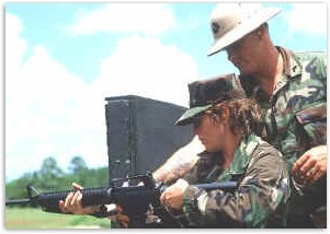 A Marine preparing to shoot her weapon
