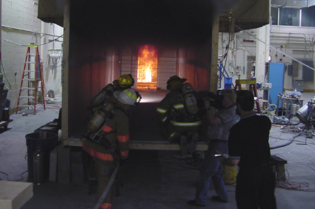 Fire fighters enter NIST multi-room fire structure during fire test.