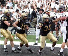 West Point defensive back Jonathan Lewis celebrates his touchdown after recovering a fumble in the end zone against the Cincinnati Bearcats. The Black Knights' 48-29 win over the Bearcats ended a U.S. Military Academy 19-game football losing streak Oct. 9.