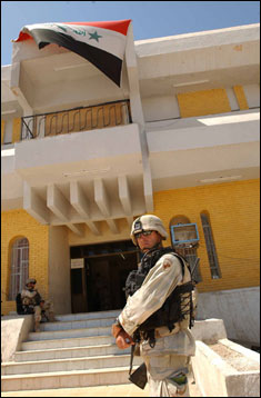 Master Sgt. Bill McGuckin stands outside an Iraqi government building in Al Kut.  McGuckin traveled to the city near Baghdad in September to assist repair damages caused by terrorist attacks.  