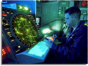 An air traffic controller monitors flight operations during carrier flight qualifications aboard USS Theodore Roosevelt (CVN 71). 