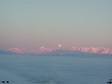 The moon above a range of mountains.