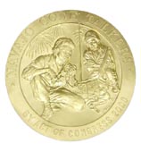Color photograph showing a close up of the first Congressional Gold Medal, a coin-shaped medal with an embossed profile of George Washington, who faces right.