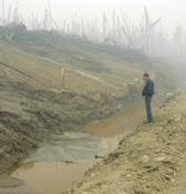 NRCS Fairbanks District Conservationist Jim Helm surveys erosion along the Steese Highway 11 miles north of Central.