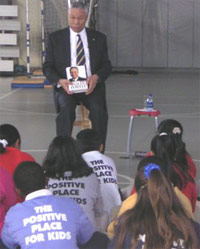 Secretary of State Colin Powell shows his book to youths at a Boys and Girls Club in Atlanta.