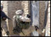 A Soldier from the 9th Engineer Battalion, 2nd Brigade, 1st Infantry Division, kicks open a gate in Samarra, Iraq, during house-to-house searches for insurgents and weapons.  This photo appeared on www.army.mil.