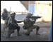 Soldiers from the 1st Infantry Division take cover and engage the enemy during a street battle in Samarra, Iraq.  This photo appeared on www.army.mil.