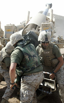 The Marines of gun five work quickly to load the first round of a fire mission.  Each Marine has different responsibilities as they work as a team to fire.  They must ensure their M109 Howitzer is set at the right direction and elevation with the proper round and charge loaded before the breech is closed. Then the lanyard is pulled and the round is fired. Photo by: Cpl. Jan Bender