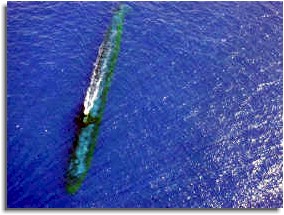 The USS Chicago (SSN 721) glides along at periscope depth in the western Pacific Ocean off the coast of Malaysia. 