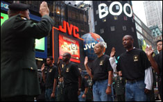 Army Vice Chief of Staff Gen. Richard A. Cody gives the oath of enlistment to New York City recruits at Times Square, N.Y., Oct. 14, in honor of the U.S. Army Recruiting Command's 40th birthday.