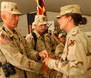 ward — Maj. Gen. Eric T. Olson, CJTF-76 commander, pins the Global War on Terrorism Expeditionary Medal on a Joint Logistic Command Soldier during the JLC's shoulder sleeve insignia ceremony at Bagram Air Base Sept. 28. 