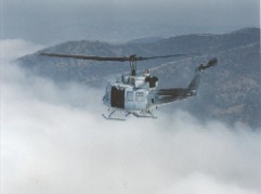 Uh1n Helicoptor flying in the clouds