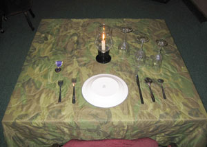A candle burns on a table set in remembrance of Cpl. Ronald R. Payne Jr., a light armored vehicle scout from Battalion Landing Team 1st Bn., 6th Marines, the ground combat element of the 22nd Marine Expeditionary Unit (Special Operations Capable), who was killed during a firefight with Taliban insurgents in Afghanistan on May 7, 2004.  The table was set during a recent Warrior's Night held by BLT 1/6 aboard Naval Station Rota, Spain. Photo by: Gunnery Sgt. Keith A. Milks