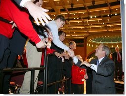 President George W. Bush greets the crowd after giving remarks to the American Associations of Community Colleges annual convention in Minneapolis, Minn., Monday, April 26, 2004. White House photo by Paul Morse.