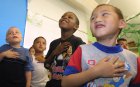 Kindergartners at Mayfair Elementary School recite the Pledge of Allegiance