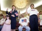 Two women take the Oath of Allegiance making them U.S. citizens, during an Independence Day naturalization ceremony  held by the Immigration and Naturalization Service