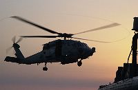 The blades of an HH-60H Seahawk helicopter makes swirls in the air as is prepares to land on the command ship USS La Salle (AGF 3). 