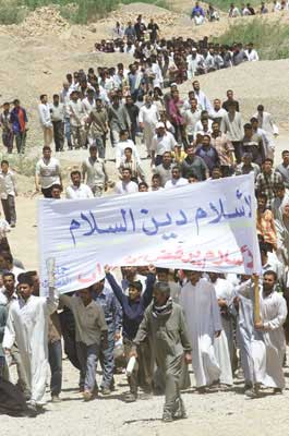 Iraqi Shiite men hold a banner