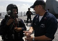 Fire Controlman 1st Class Michael Davidson, assigned to USS Cowpens (CG 63), speaks with a member of a Visit, Board, Search and Seizure (VBSS) Team from the Indian Navy Delhi-class destroyer INS Mysore (D 62).