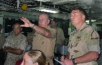 Chief of Naval Operations (CNO), Adm. Vern Clark,  is briefed aboard amphibious assault ship USS Essex (LHD 2) during his tour of the Middle East region. 