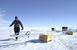 A person with science equipment on a snow field.