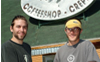Photo of two men standing in front of a coffee shop