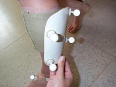 Shell shown with reflective markers applied to front and about to be placed on subject's calf.