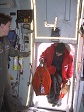 A man boards an aircraft while a female loadmaster looks on.