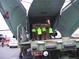 Soldiers load cargo onto a military aircraft.