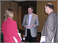 Photo of a Regional Director Craig speaking with two people.