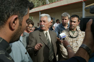 Iraqi Gen. Mohammed Latif, commander of the Fallujah Brigade, is swarmed by media shortly after a press conference for more questions and answers in Fallujah, May 20.  The general said the city is ready to move forward with reconstruction projects.
(USMC photo by Sgt. Jose E. Guillen) Photo by: Sgt. Jose E. Guillen
