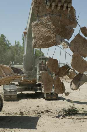 Heavy lifting help came in the form of Army Sgt. Jake W. Sharp, a heavy equipment operator with Company A, 120th Engineer Combat Battalion, as he loads another dump truck with rubble and earth to make way for a new firing range at Camp India, Iraq. The camp is located inside an Iraqi Civil Defense Corps base, which has begun cycling ICDC soldiers through seven-day training evolutions.
(USMC photo by Sgt. Jose E. Guillen) Photo by: Sgt. Jose. E. Guillen