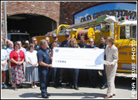 FEMA Region IX Deputy Regional Director Karen Armes presents Georgetown Fire Protection District Chief Rick Todd with a check for $175,500.