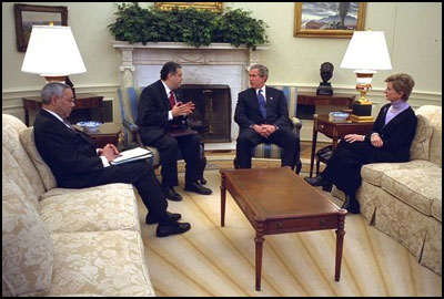 President George W. Bush meets with Secretary of State Colin Powell, left, Secretary of Energy Spencer Abraham, center, and EPA Administrator Christine Todd Whitman in the Oval Office Thursday, Feb. 27, 2003. White House photo by Paul Morse. 