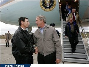 President George W. Bush meets USA Freedom Corps Greeter Jeff Kemp at Outagamie County Regional Airport in Appleton, Wisconsin, Friday, Oct. 15, 2004. For the past 12 years, Jeff has volunteered in the Oshkosh and Omro school districts. Once per week, he visits elementary school classrooms and reads to students. White House Photo by Eric Draper.