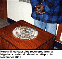 photo - Heroin-filled capsules recovered from a Nigerian courier at Islamabad Airport in November 2001