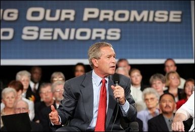 President George W. Bush makes a point during a conversation on Medicare-approved prescription drug discount cards in Liberty, Mo., June 14, 2004