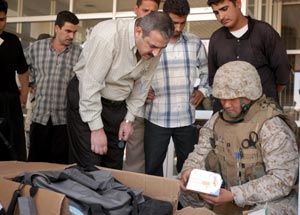 Navy Lt. Kenneth Y. Son, 2nd Battalion, 4th Marine Regiment surgeon, shows Iraqi Dr. Qussai Najem Abdulla medical supplies donated by the battalion. Nearly $50,000 worth of basic medical equipment was taken to the Ar Ramadi General Hospital recently.
(USMC photo by Cpl. Paula M. Fitzgerald) Photo by: Cpl. Paula M. Fitzgerald