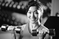 Photo of young woman with hand weights.