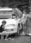 Photo of family washing the car.