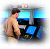 A person aboard ship in front of the radar screen
