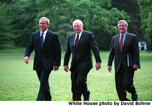 Photograph of the President, Vice President and Chief of Staff walking across the White House Lawn. White House photo by David Bohrer.