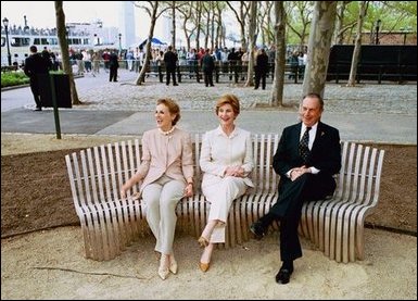 Laura Bush sits on a new park bench with New York City Mayor Michael Bloomberg and The Battery Conservancy Founder and President Warrie Price, left, after the dedication of the 'Gardens of Remembrance' in New York's Battery Park, Monday, May 10, 2004. White House photo by Tina Hager.