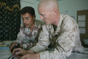 1st Lt. Allen R. McBroom, 30, a  platoon commander for Weapons Company, 2nd Battalion, 7th Marine Regiment, discusses current operations with an Iraqi Civil Defense Corps soldier.  The Marines and ICDC soldiers are interacting more during current operations.
(USMC photo by Sgt. Jose L. Garcia) Photo by: Sgt. Jose L. Garcia