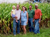 Left to Right: Anna Baker, held by father Mark Baker, Lisa Baker (wife of Mark Baker) and the Baker brothers (also operators at Borderview Farms) Phil Baker and Dan Baker.