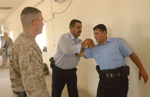 Sgt. Jim Marble, a member of the 1st Marine Division's Iraqi Police Liaison Team, observes techniques practiced by members of Task Force Cobra, a group of Iraqi police.  The Iraqi police received a short course of advanced training designed to raise the standards of professionalism and capabilities for the Iraqi police.
(USMC photo by Cpl. Shawn C. Rhodes) Photo by: Cpl. Shawn C. Rhodes