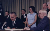 President Johnson signs Medicare into law.