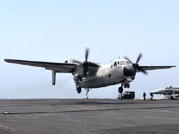 A C-2 Greyhound approaches an aircraft carrier for landing